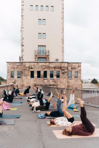Yoga-Kurs auf dem Dach mit Blick auf den Marathonturm in Chemnitz.